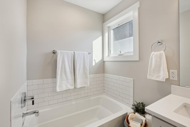 bathroom featuring vanity and a bath