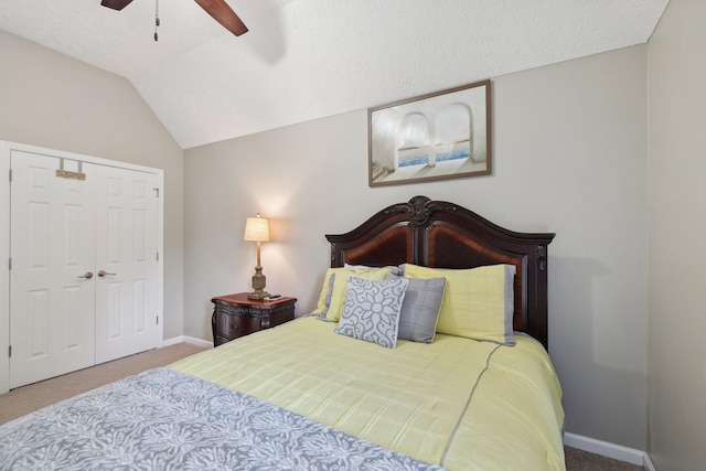 bedroom with ceiling fan, a closet, carpet, and lofted ceiling