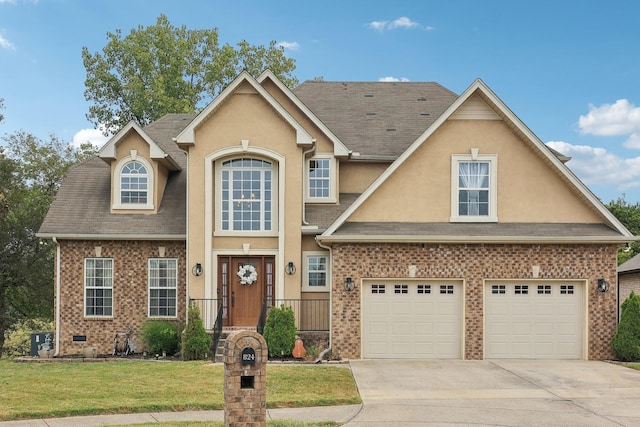 view of front of house with a garage and a front yard