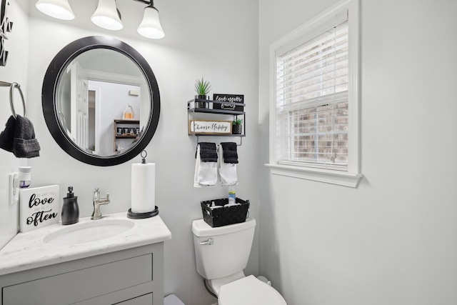 bathroom featuring vanity and toilet