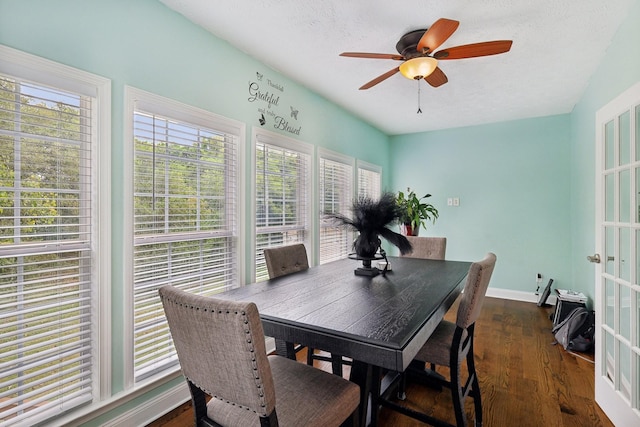 dining room with dark hardwood / wood-style floors, ceiling fan, and a textured ceiling