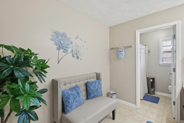 sitting room with light tile patterned floors and a textured ceiling