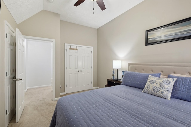 carpeted bedroom featuring ceiling fan, a closet, and lofted ceiling