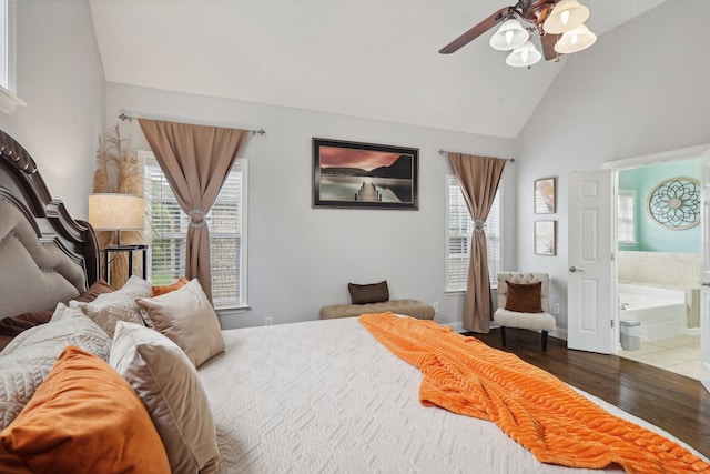 bedroom featuring ceiling fan, dark hardwood / wood-style floors, high vaulted ceiling, and ensuite bath