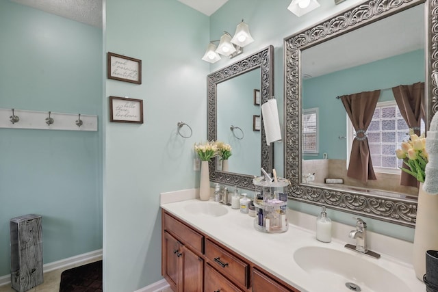 bathroom featuring tile patterned flooring, a textured ceiling, and vanity