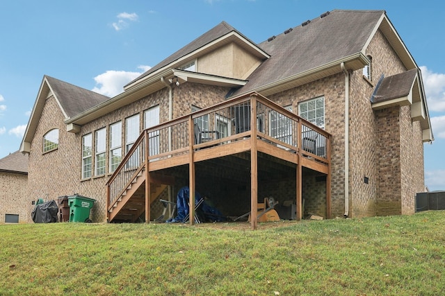 back of house featuring a lawn, a wooden deck, and cooling unit