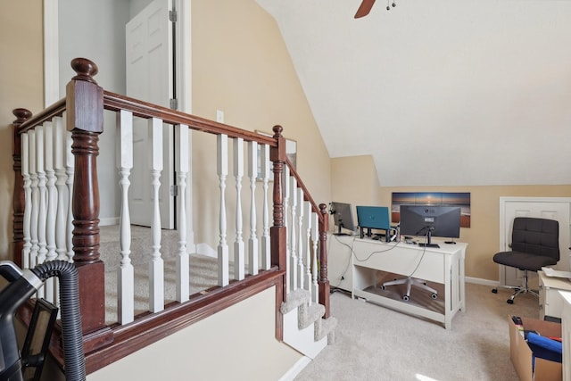 interior space with ceiling fan, lofted ceiling, and carpet floors