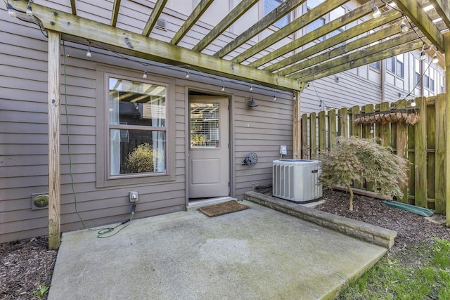 doorway to property with cooling unit, a pergola, and a patio