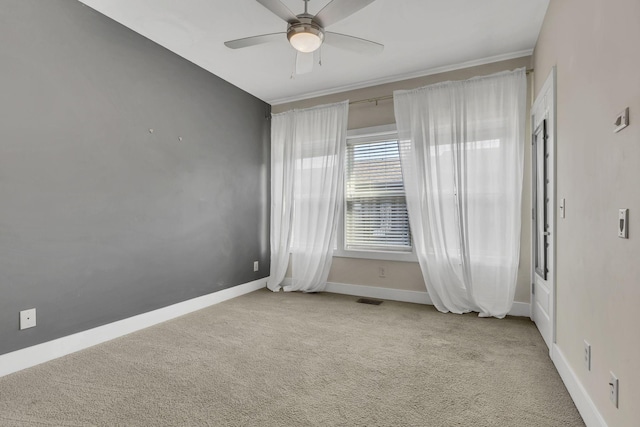 carpeted spare room featuring ceiling fan