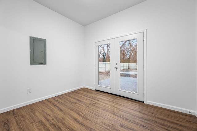 spare room featuring wood-type flooring, french doors, and electric panel