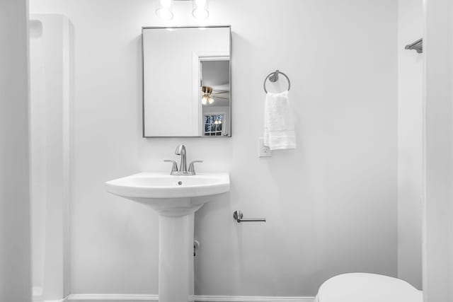 bathroom with toilet and ceiling fan