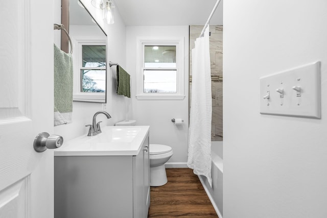 full bathroom featuring toilet, shower / bathtub combination with curtain, hardwood / wood-style floors, and vanity