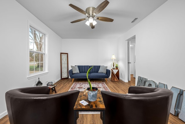 living room with ceiling fan and hardwood / wood-style floors