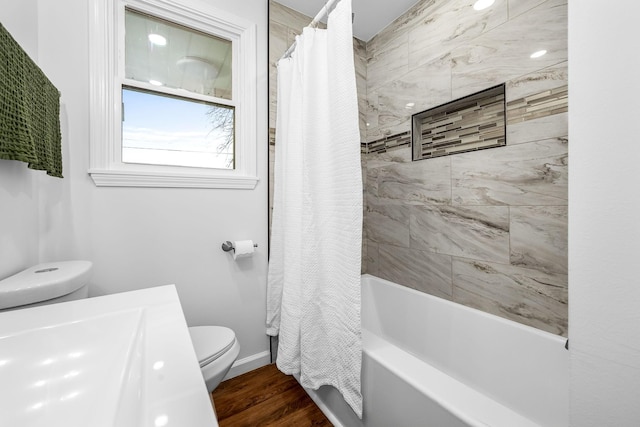 bathroom featuring toilet, wood-type flooring, and shower / bath combo