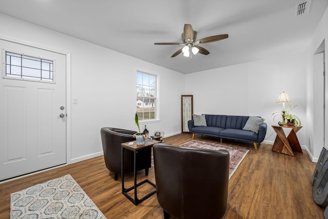 living room with ceiling fan and dark hardwood / wood-style flooring