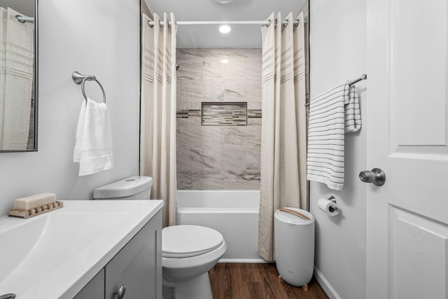 full bathroom featuring shower / bath combo with shower curtain, wood-type flooring, toilet, and vanity