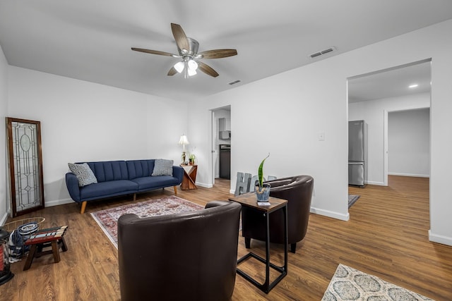 living room with ceiling fan and hardwood / wood-style flooring