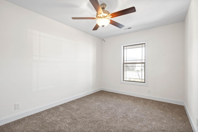 carpeted spare room with ceiling fan