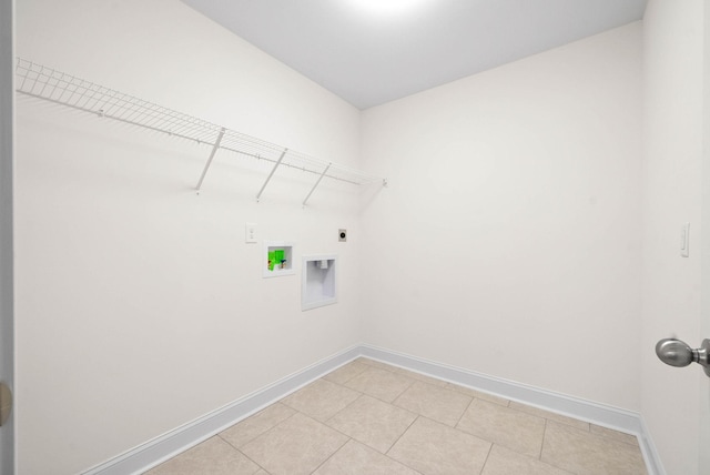 washroom with washer hookup, light tile patterned floors, and hookup for an electric dryer