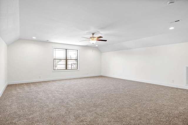 carpeted empty room featuring ceiling fan and lofted ceiling