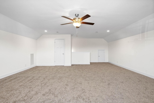 additional living space with ceiling fan, lofted ceiling, and carpet flooring