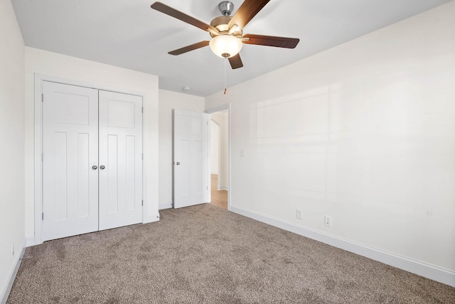 unfurnished bedroom with carpet, ceiling fan, and a closet