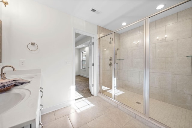 bathroom with vanity, tile patterned flooring, and a shower with shower door