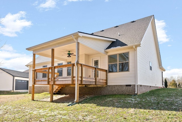 back of property with ceiling fan, a wooden deck, and a lawn