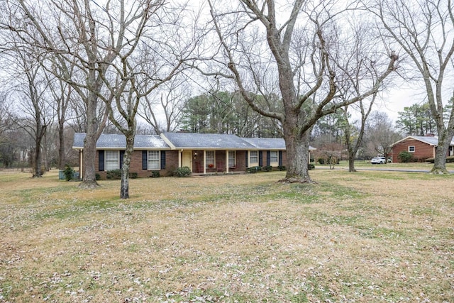 ranch-style home featuring a front yard