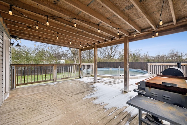 wooden terrace featuring a fenced in pool