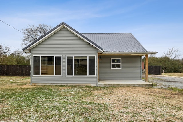 back of property featuring a lawn