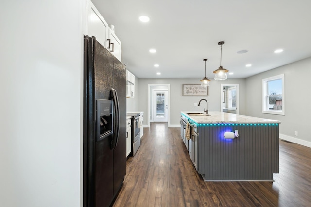 kitchen with white cabinetry, sink, black refrigerator with ice dispenser, an island with sink, and decorative light fixtures