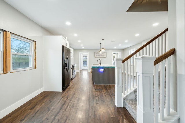 hallway featuring dark hardwood / wood-style flooring and sink