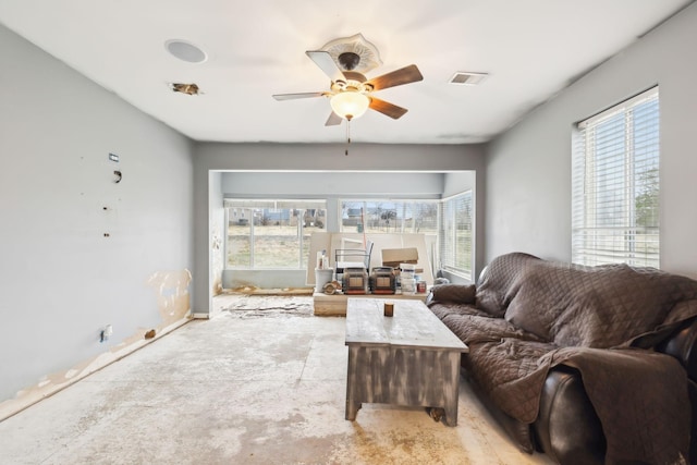 living room with plenty of natural light and ceiling fan