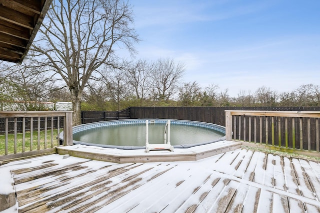 wooden deck featuring a fenced in pool