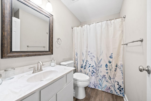 bathroom featuring walk in shower, toilet, vanity, and hardwood / wood-style flooring