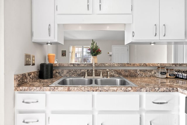 kitchen featuring white cabinets and sink