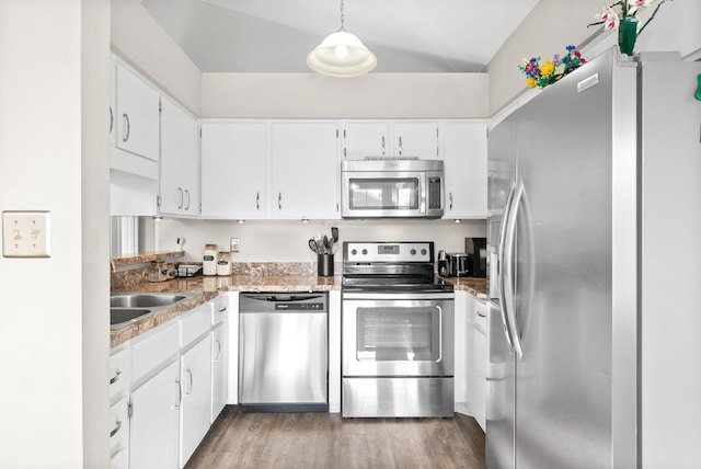 kitchen featuring dark hardwood / wood-style flooring, white cabinets, stainless steel appliances, and decorative light fixtures