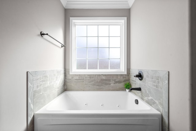 bathroom featuring ornamental molding and a tub to relax in