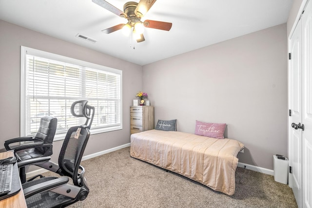 carpeted bedroom featuring ceiling fan and a closet