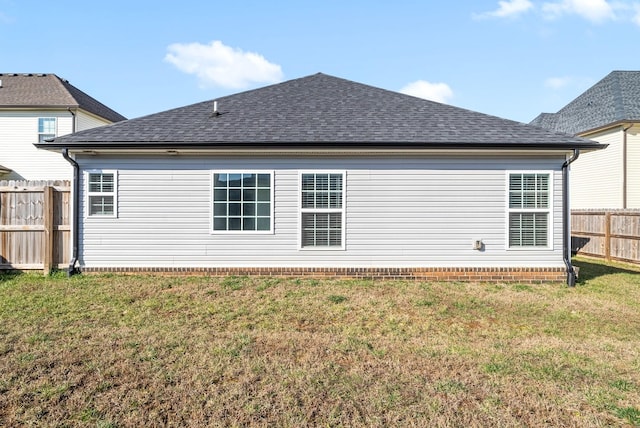 rear view of property with a yard