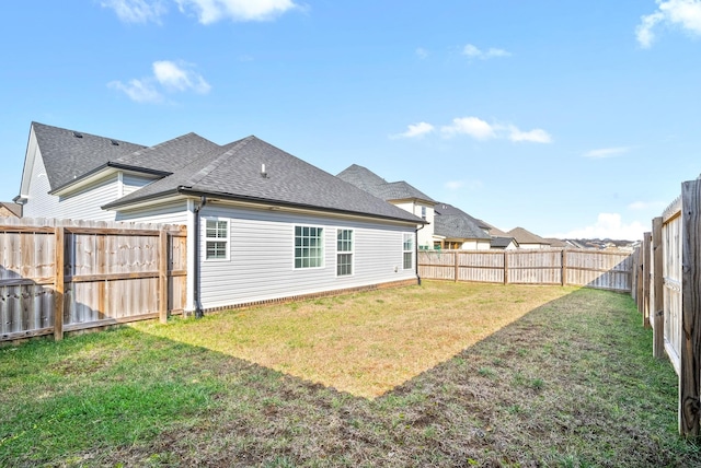 rear view of property featuring a lawn