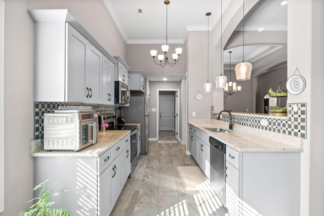 kitchen featuring pendant lighting, backsplash, sink, a notable chandelier, and stainless steel appliances