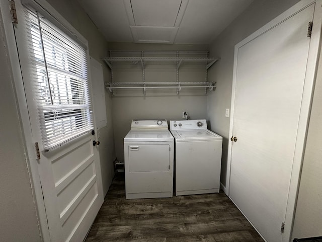 laundry room with washing machine and dryer and dark wood-type flooring