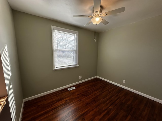 spare room featuring dark hardwood / wood-style floors and ceiling fan