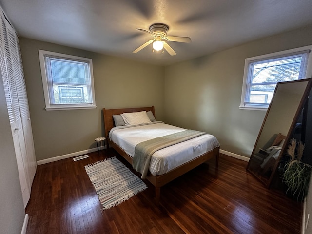 bedroom featuring ceiling fan, dark hardwood / wood-style flooring, and a closet