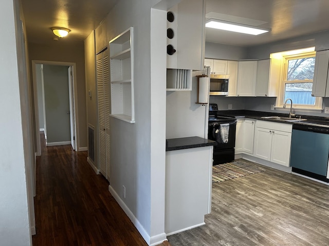 kitchen with white cabinets, sink, stainless steel appliances, and dark wood-type flooring