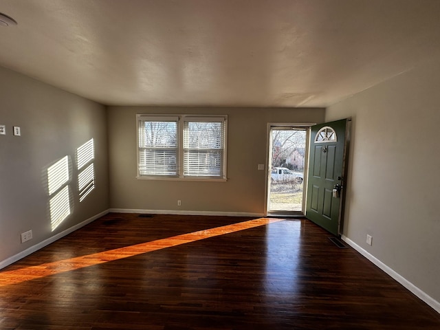 foyer entrance featuring dark wood-type flooring