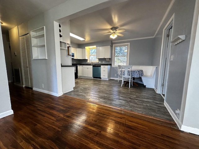 kitchen with dark hardwood / wood-style flooring, stainless steel dishwasher, ceiling fan, sink, and white cabinets