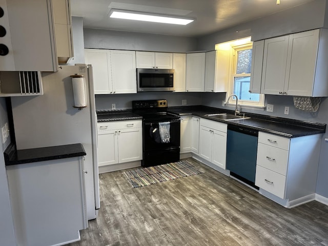 kitchen featuring white cabinetry, sink, stainless steel appliances, and dark hardwood / wood-style floors